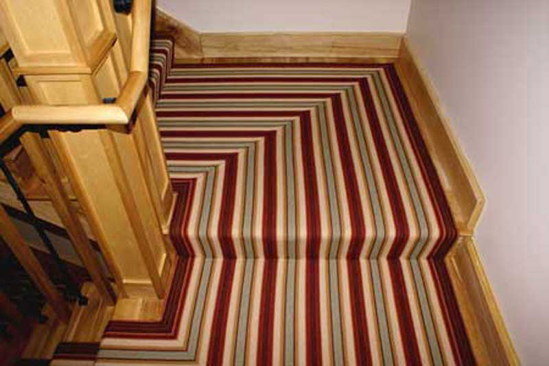 Here's one of our traditionally inspired Venetian carpets
installed in a ha// and staircase. You can have custom carpet and superior quality in a modem adaptation of a historic carpet design.