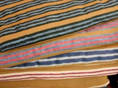A closeup view of a stack of Acadian style blankets.